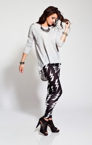 Full lenght portrait of contemporary young woman wearing rock style clothes. Studio shot, white background.