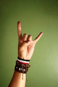 Photo of a hand making a rock and roll sign
